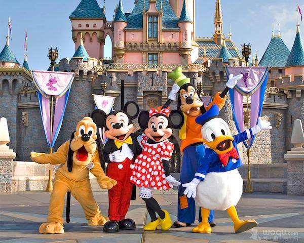 Cute Micky Mouse Family Standing Infront of Disneyland Themed Party Celebration.